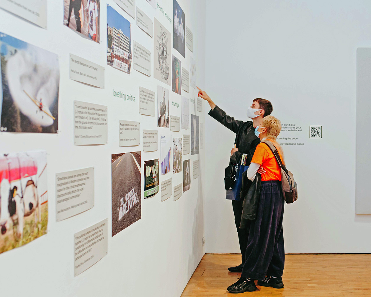 a man and a woman point at a collage